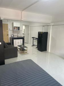 a living room with a couch and a kitchen at The pink palace in Karon Beach +21 photos