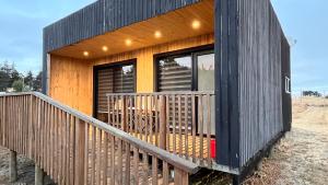 a wooden house with a large deck at COSTA LOBO ll in Pichilemu