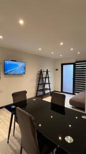 a dining room with a black table and chairs at COSTA LOBO ll in Pichilemu