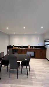 a dining room with a table and chairs in a room at COSTA LOBO ll in Pichilemu