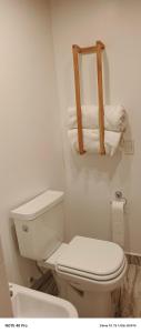 a white bathroom with a toilet and towels at Entre Cerros in Maimará +26 photos