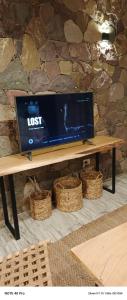a laptop computer sitting on a wooden table at Entre Cerros in Maimará