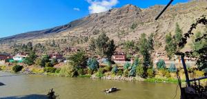a view of a river with a mountain in the background at Qenti Label House in Pisac