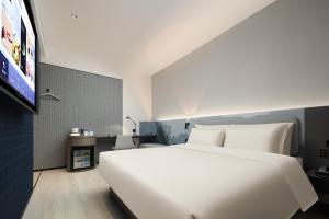 Voodi või voodid majutusasutuse Atour Light Hotel Hangzhou Sijiqing Nanxingqiao Metro Station toas