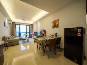 a kitchen and living room with a table and a refrigerator at 慕海Mosea悠享海景三卧房4806 in Johor Bahru