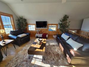 a living room with a couch and a table at The Jefferson Guest House in Litchfield