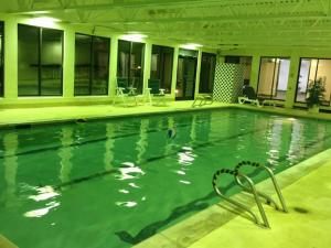 a swimming pool in a hotel with chairs and tables at Best Ski Condo, Winter Park, USA in Winter Park