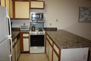 a kitchen with a stove and a microwave at Best Ski Condo, Winter Park, USA in Winter Park +22 photos
