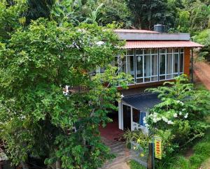 an aerial view of a house with trees at Thusara Guesthouse in Mirissa