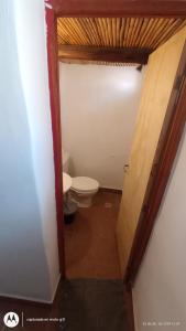 a hallway to a bathroom with a toilet in it at Tampu 4 alojamiento in Purmamarca