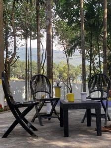 a table and two chairs and a table and a table and chairs at Naljuri Inn in Sylhet
