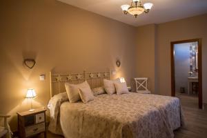 a bedroom with a large bed with pillows on it at Hotel Rural Sisapo in Almodóvar del Campo +42 photos
