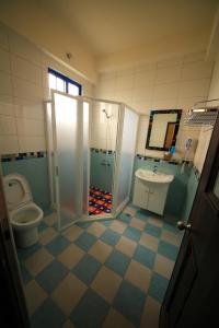 a bathroom with a toilet and a shower and a sink at Blue Bay in Green Island