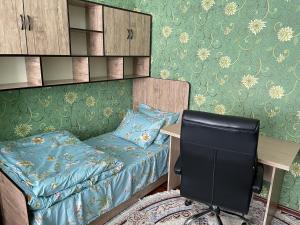 a bedroom with a bed and a desk and a chair at Three rooms Apartment with all facilities in Tashkent