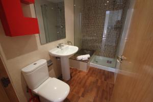 a bathroom with a toilet and a sink and a shower at ACP Cambrils Puerto Apartamentos in Cambrils +42 photos