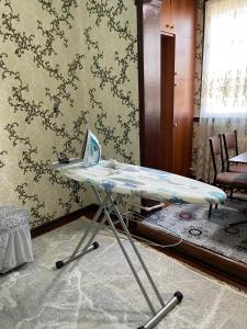 a table with a laptop on it in a room at Three rooms Apartment with all facilities in Tashkent