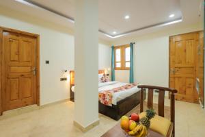 a bedroom with a bed and a table with a bowl of fruit at Mystic Hills Retreat in Shimla +47 photos