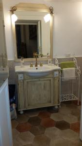 a bathroom with a sink and a mirror at La Dimora Del Professore in Naples