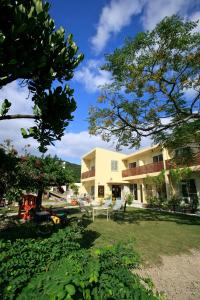 a building with a picnic table in a yard at Cha Villa in Zamami
