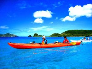 a group of people in a red kayak in the water at Cha Villa in Zamami