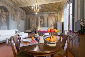a dining room with a table with fruit on it at Era Rental Apartments in Florence