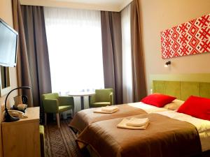 Łóżko lub łóżka w pokoju w obiekcie Hotel *** NAT Krynica Zdrój