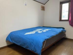 Postel nebo postele na pokoji v ubytování 福島小月
