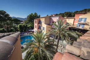 a view from the balcony of a villa with a swimming pool at Hotel Byblos Saint-Tropez in Saint-Tropez