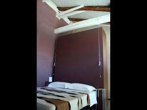Un pat sau paturi într-o cameră la Agriturismo CasaMatilda