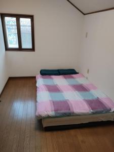 Postel nebo postele na pokoji v ubytování 福島小月