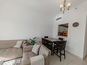 a living room with a couch and a table at Silicon Heights II in Dubai
