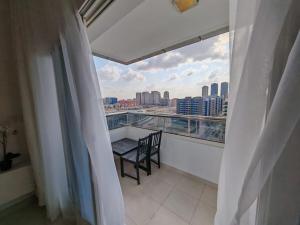 a balcony with a table and a view of a city at Silicon Heights II in Dubai