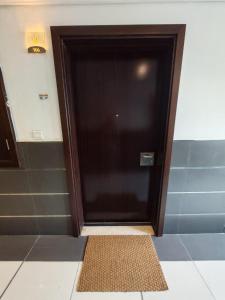 a door in a room with a mat in front of it at Silicon Heights II in Dubai +6 photos