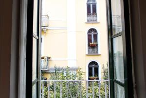 an open window looking out at a building at Grigio Pesca in Salerno