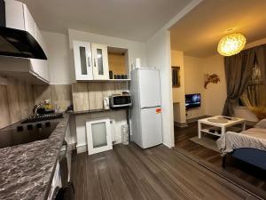 a kitchen with a refrigerator and a living room at Grove Rooms 2 in London +20 photos