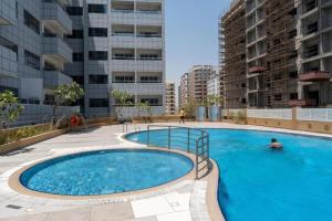a large swimming pool in the middle of a building at Silicon Heights II in Dubai