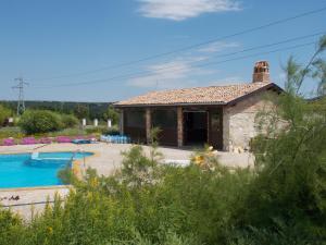 a stone house with a pool in front of it at Villa Ketli Apartment in Bliznatsi