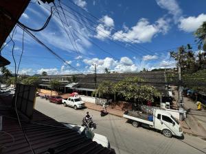 a white truck parked on the side of a street at Truman Hostel in Luang Prabang +14 photos