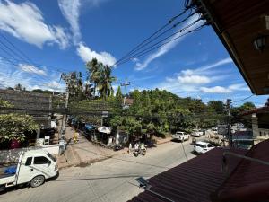 a small white truck parked on the side of a street at Truman Hostel in Luang Prabang