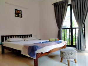 a bedroom with a bed and a large window at Riviera Sublime Holiday Homes in Siolim +35 photos