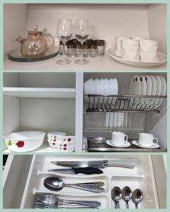 a kitchen with dishes and wine glasses and utensils at 2-х комнатная квартира in Kokshetau +1 photo