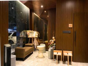 a room with a store with a couch and a chair at The W Avenue in Bandung