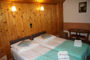 a bedroom with a bed with two towels on it at Róża in Szklarska Poręba +4 photos