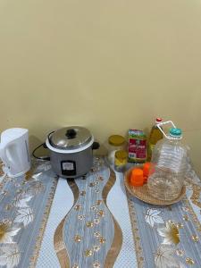 a table with a slow cooker and other ingredients on it at D'Padang KB Homestay in Kuala Berang