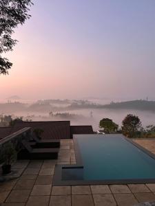 einen Pool auf dem Dach eines Hauses mit Aussicht in der Unterkunft Sylvan Retreat - Luxury Mountain Cottages in Vagamon