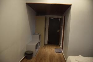 an empty room with a hallway with a door and a staircase at Hotel Christo's in Velānganni