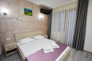Postel nebo postele na pokoji v ubytování Hotel Coralis