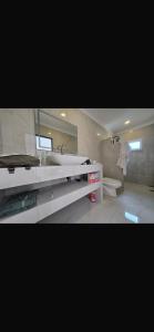 a bathroom with a sink and a tub and a toilet at Alice house in Ko Bu Bu