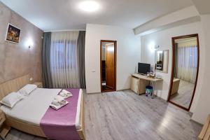 Postel nebo postele na pokoji v ubytování Hotel Coralis