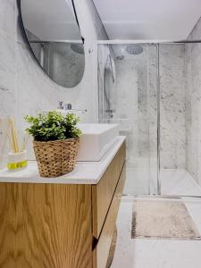a bathroom with a sink and a shower at Cozy Luxury Apartment in Aveiro in Aveiro